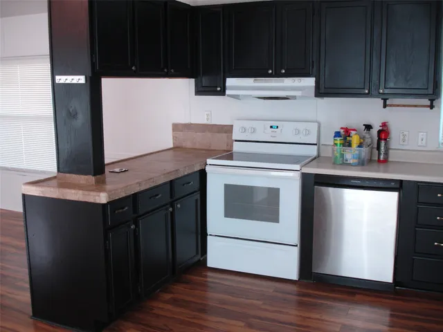 a kitchen with stainless steel appliances wooden cabinets and a sink