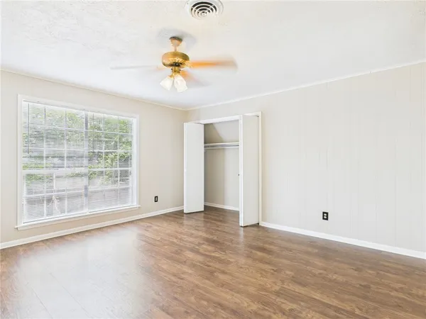 wooden floor in an empty room with a window