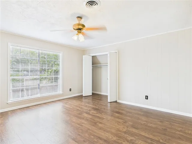 wooden floor in an empty room with a window