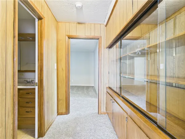 a bathroom with a glass shower door and a sink