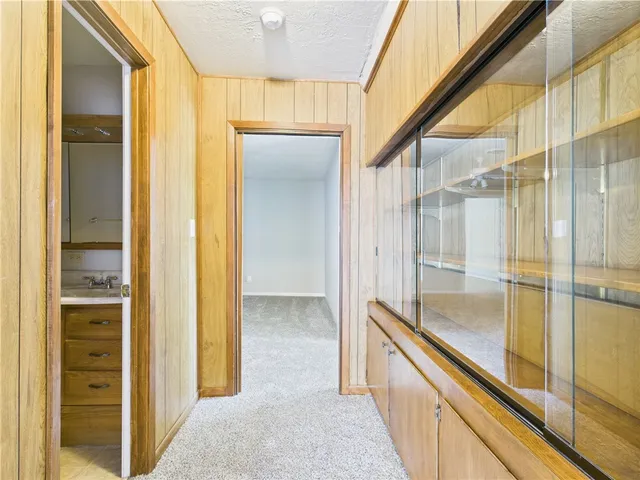 a bathroom with a glass shower door and a sink