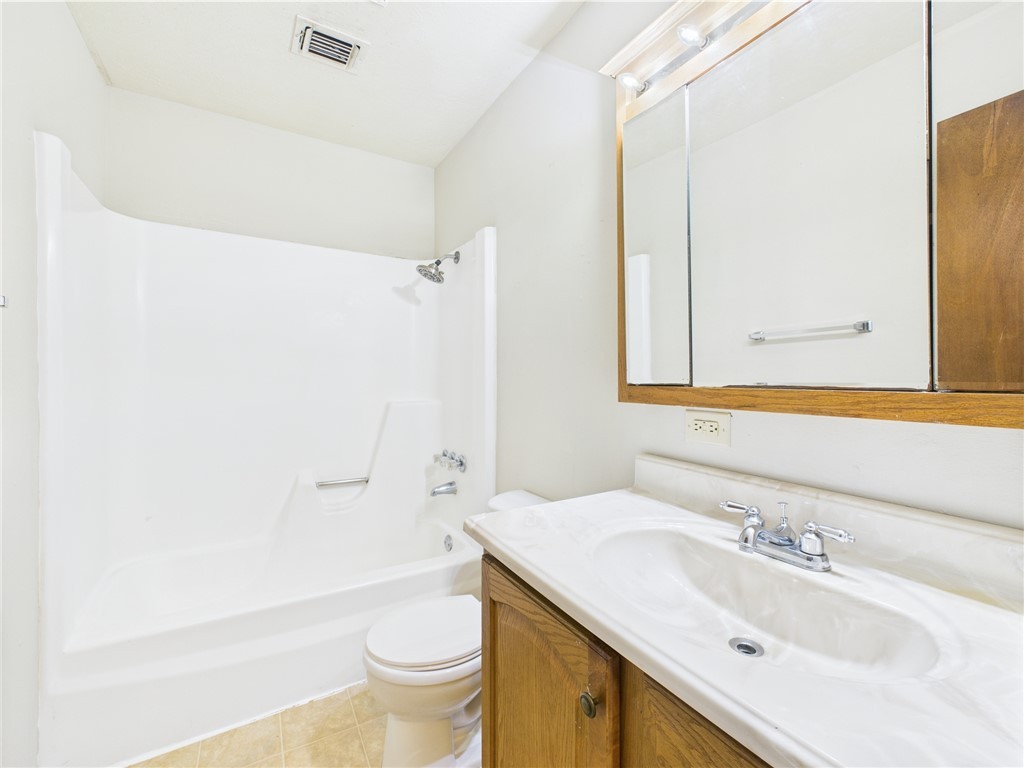 749 Meadow Lane Bryan, TX 77802 - Photo 14 of 47 a bathroom with a sink toilet and shower