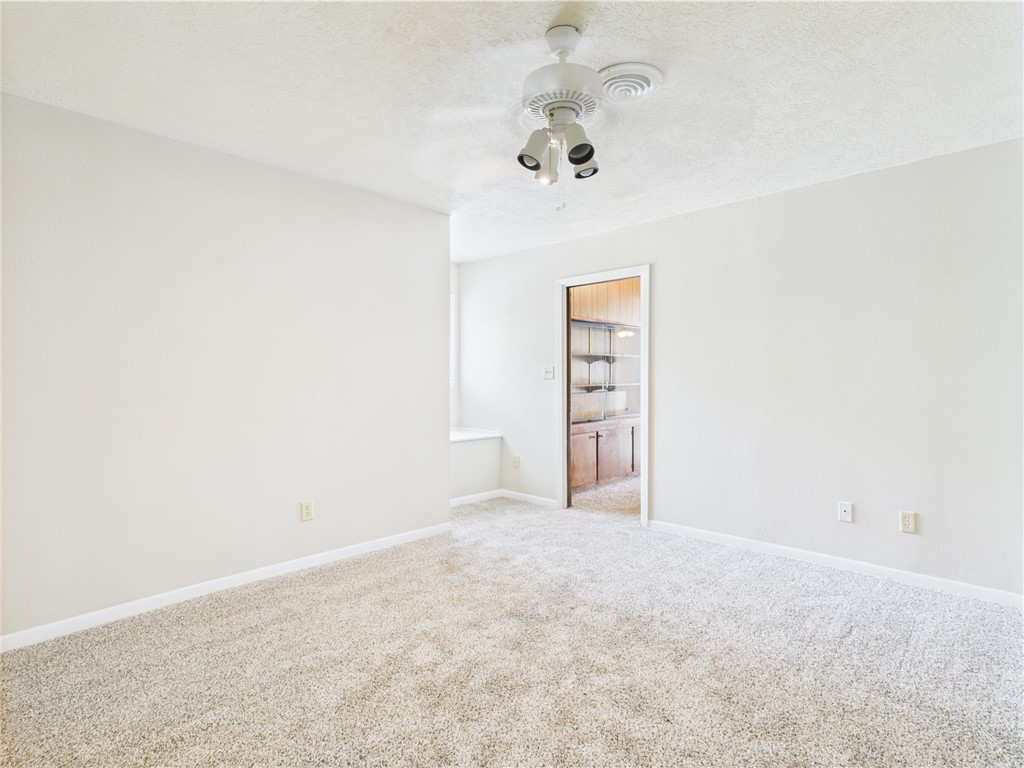 749 Meadow Lane Bryan, TX 77802 - Photo 17 of 47 an empty room with a chandelier fan