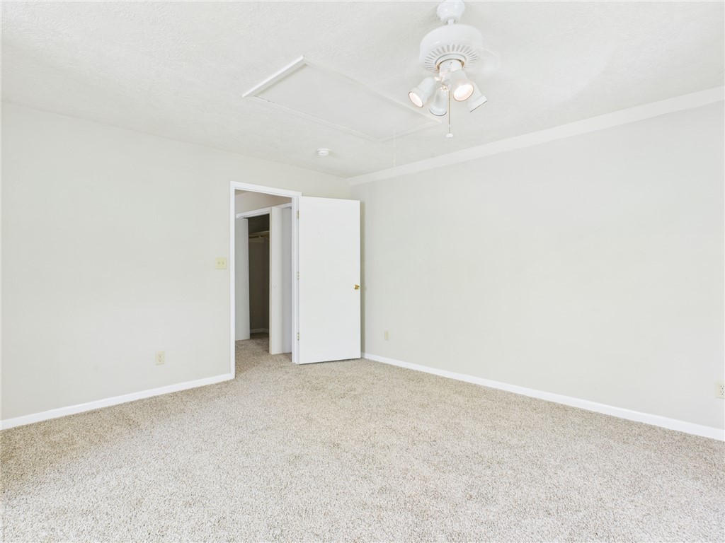 749 Meadow Lane Bryan, TX 77802 - Photo 19 of 47 an empty room with wooden floor and windows