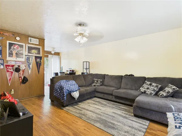 a living room with furniture and wooden floor
