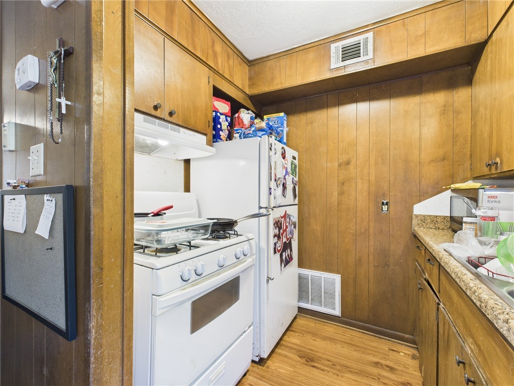 749 Meadow Lane Bryan, TX 77802 - Photo 27 of 47 a kitchen with stainless steel appliances granite countertop a sink a stove and a refrigerator