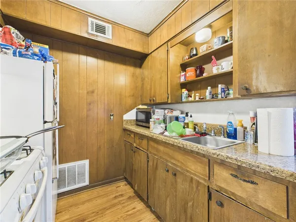 a kitchen with refrigerator and cabinets