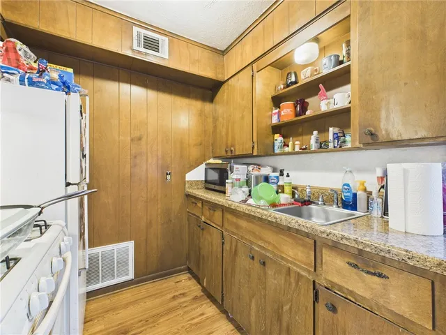 a kitchen with refrigerator and cabinets