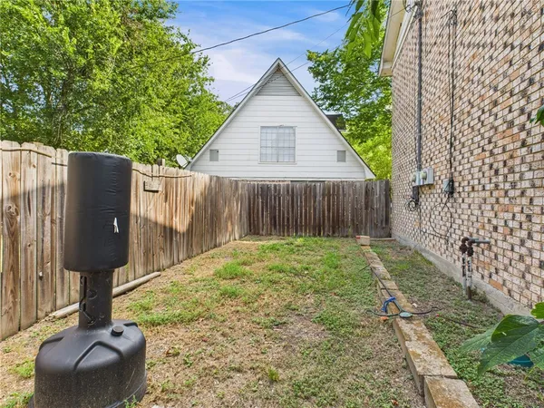 a backyard of a house with table and chairs