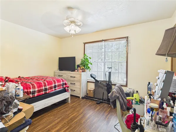 a bedroom with bed and flat screen tv