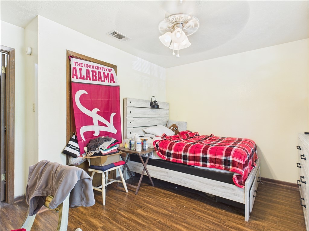 749 Meadow Lane Bryan, TX 77802 - Photo 34 of 47 a bedroom with a bed and wooden floor