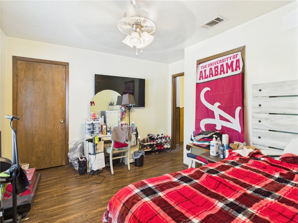 749 Meadow Lane Bryan, TX 77802 - Photo 35 of 47 a bedroom with a bed and a chandelier