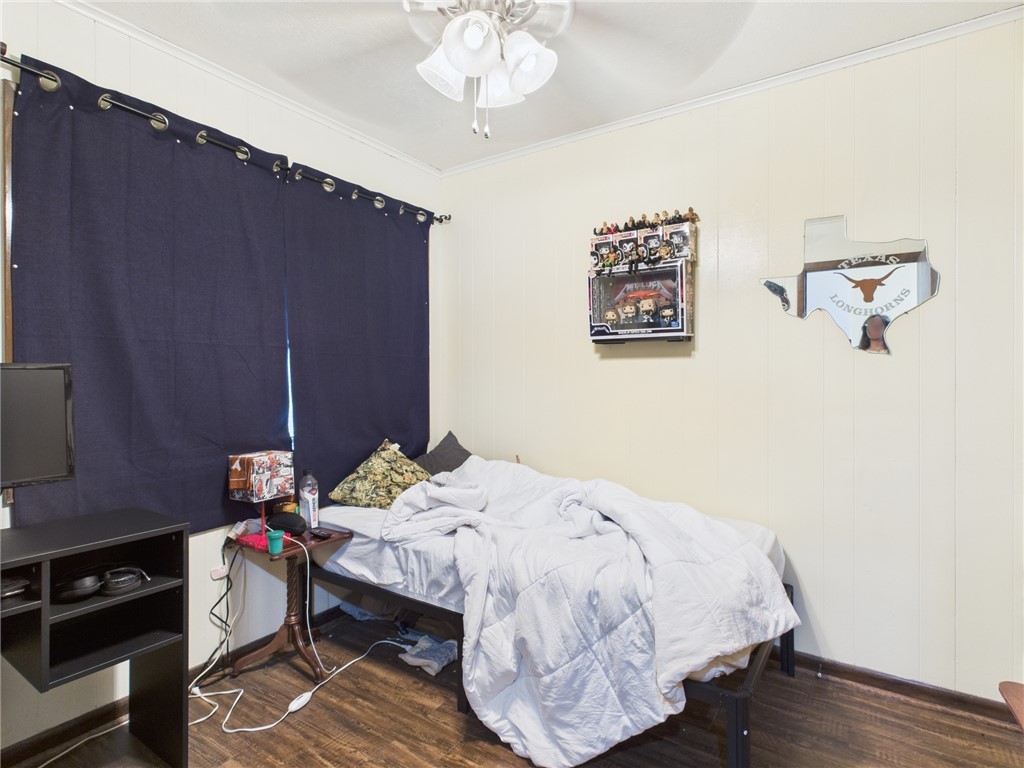 749 Meadow Lane Bryan, TX 77802 - Photo 36 of 47 a bedroom with a bed and wooden floor