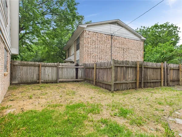a bathroom with a small yard and wooden fence