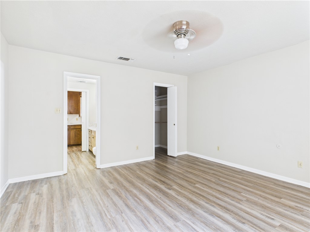 749 Meadow Lane Bryan, TX 77802 - Photo 9 of 47 an empty room with wooden floor and windows