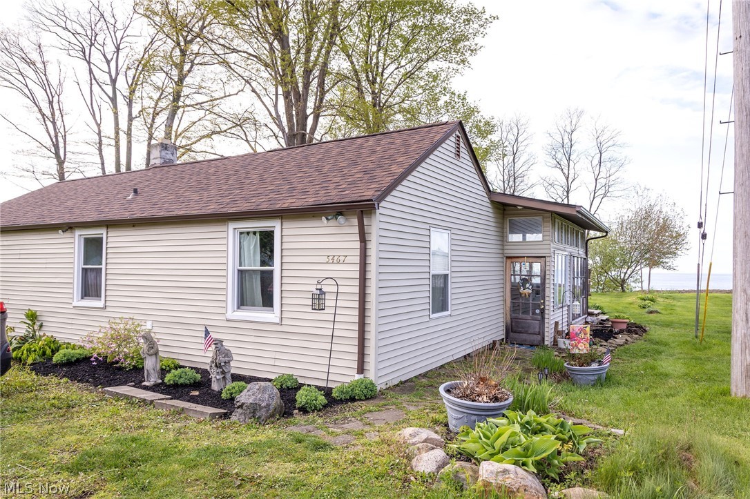 Ranch-style exterior with beige siding and a brown shingle roof