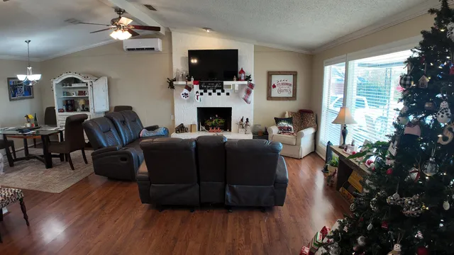 a living room with furniture a flat screen tv and a fireplace