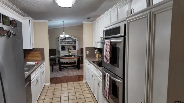 a kitchen with granite countertop a refrigerator and a stove