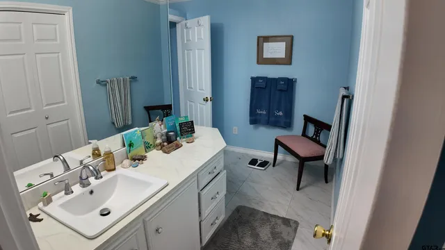 a bathroom with a sink toilet and a mirror