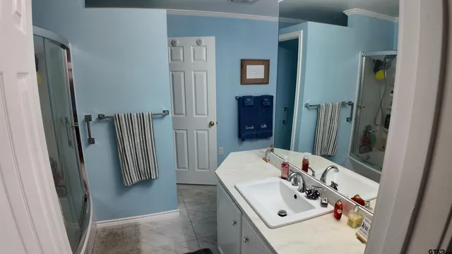a bathroom with a sink vanity and mirror
