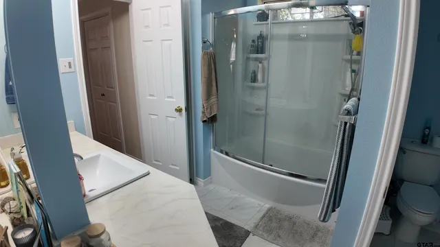 a bathroom with a shower and toilet