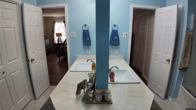 wooden floor with view of bathroom
