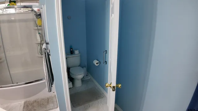 a bathroom with a granite countertop toilet