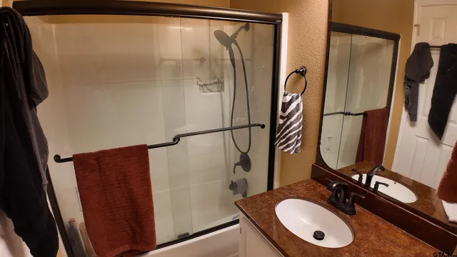 a bathroom with a sink vanity and a mirror