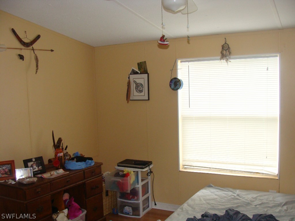 7421 Pinehurst Road Bokeelia, FL 33922 - Photo 3 of 21 a bedroom with a bed and a window