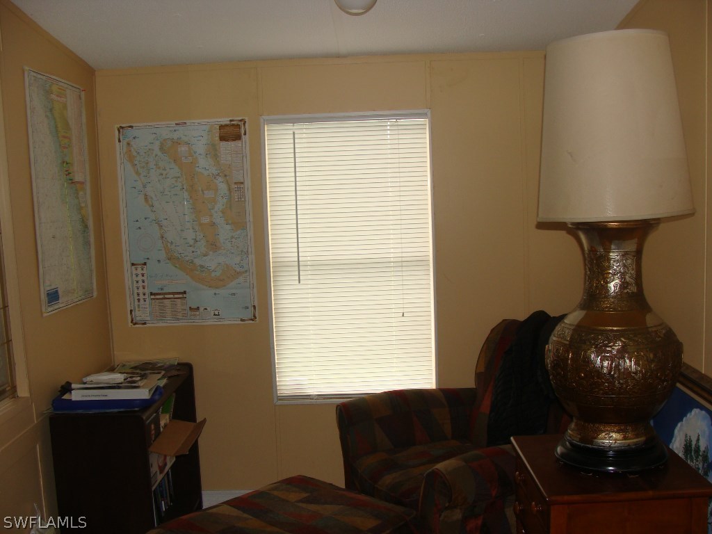 7421 Pinehurst Road Bokeelia, FL 33922 - Photo 5 of 21 a living room with furniture and a window