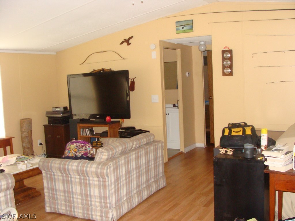 7421 Pinehurst Road Bokeelia, FL 33922 - Photo 8 of 21 a bedroom with a bed and flat screen tv