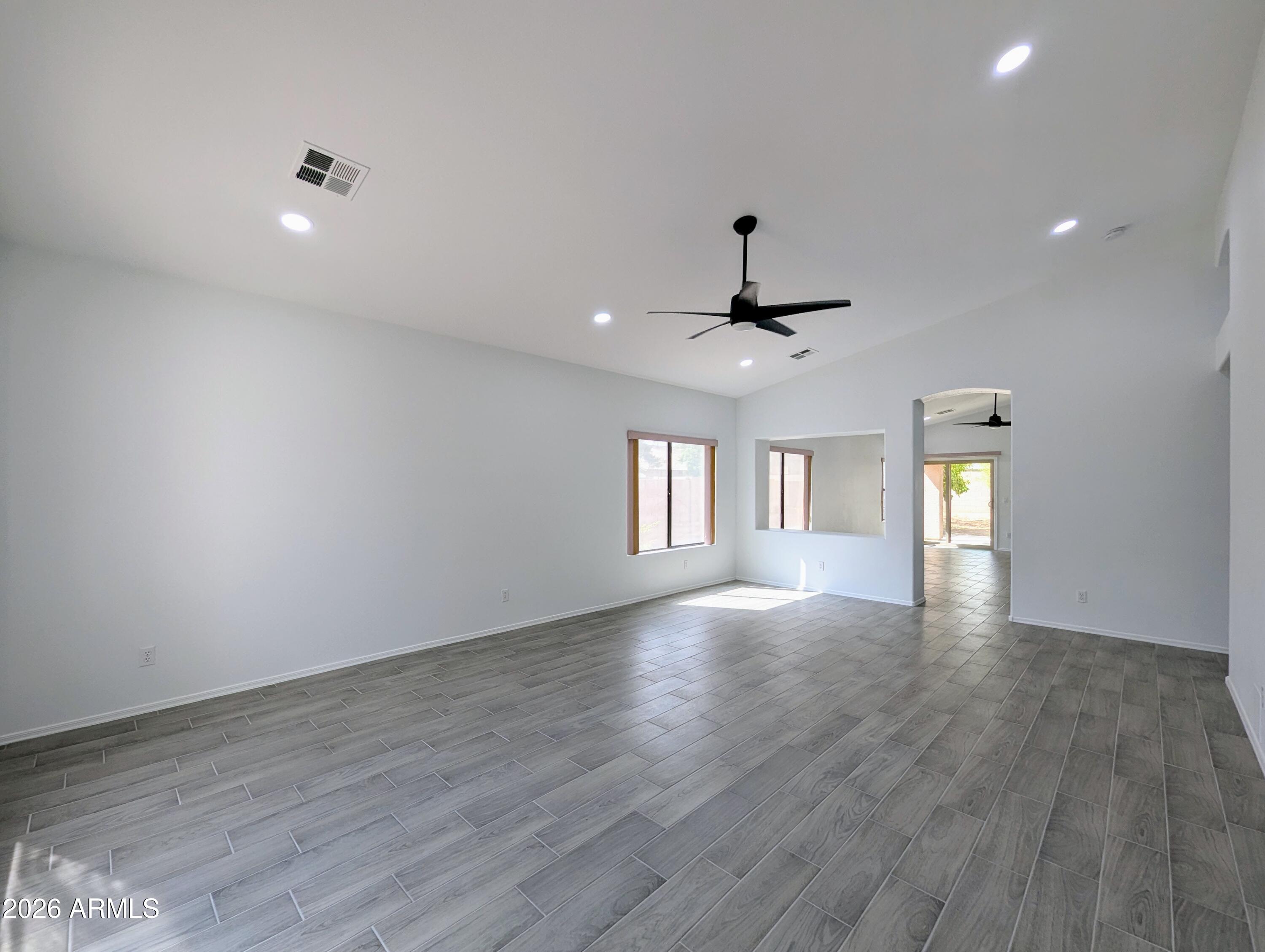 5424 West Wagoner Road Glendale, AZ 85308 - Photo 5 of 37 a view of an empty room with window and wooden floor