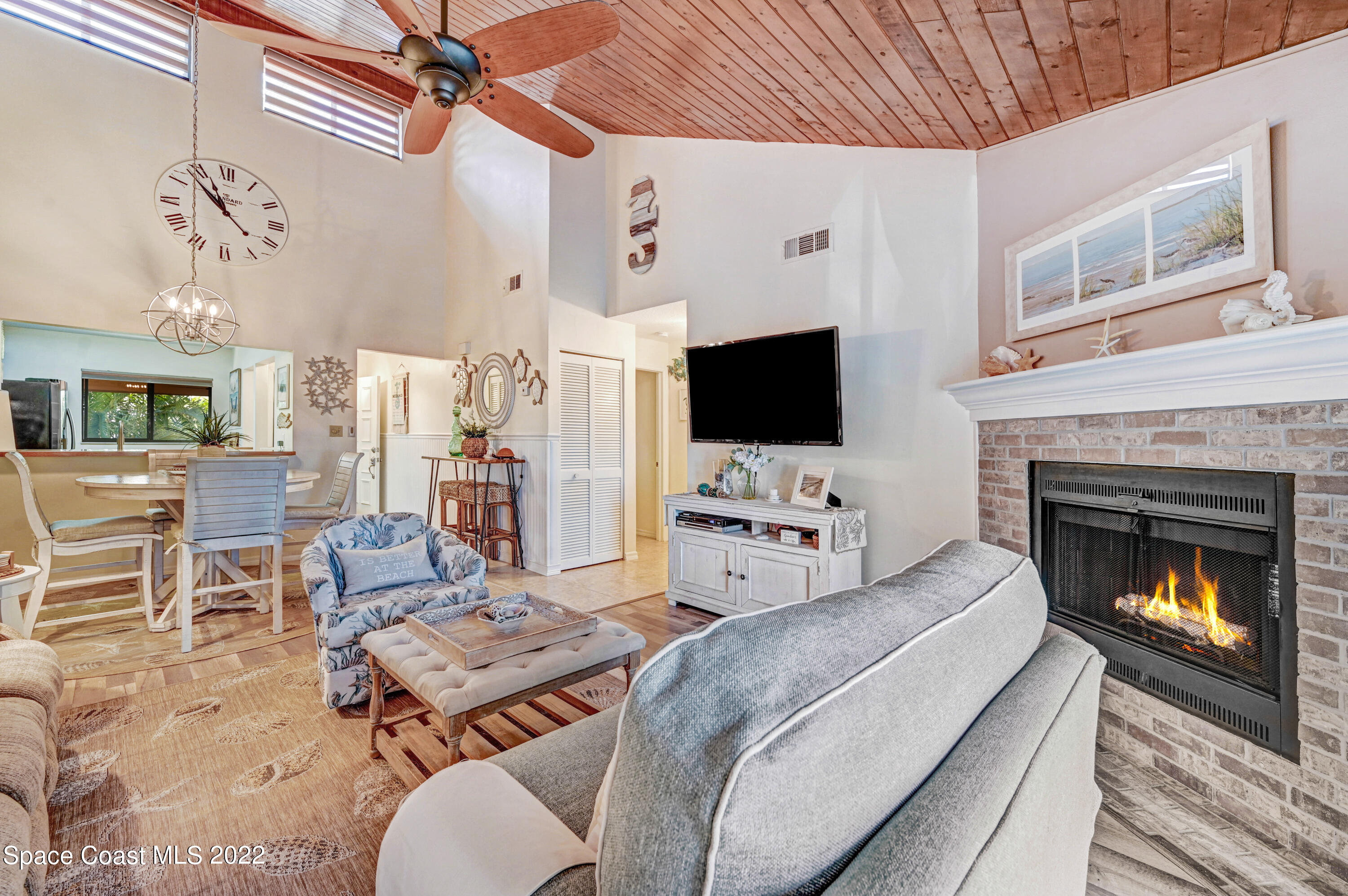 2929 Kirkland Road Northeast Palm Bay, FL 32905 - Photo 16 of 32 a living room with furniture a flat screen tv and a fireplace