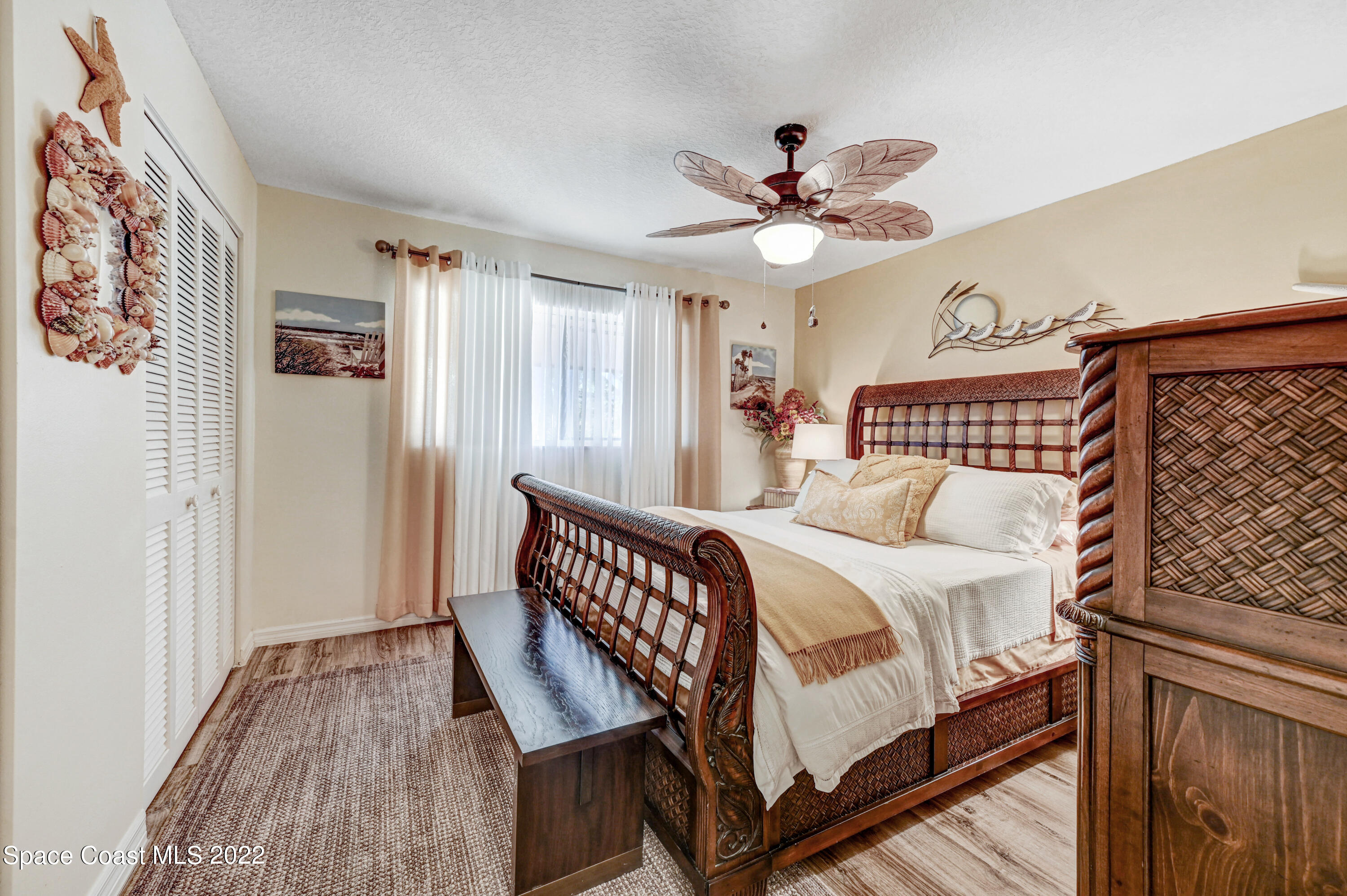 2929 Kirkland Road Northeast Palm Bay, FL 32905 - Photo 18 of 32 a bedroom with a bed and a chandelier