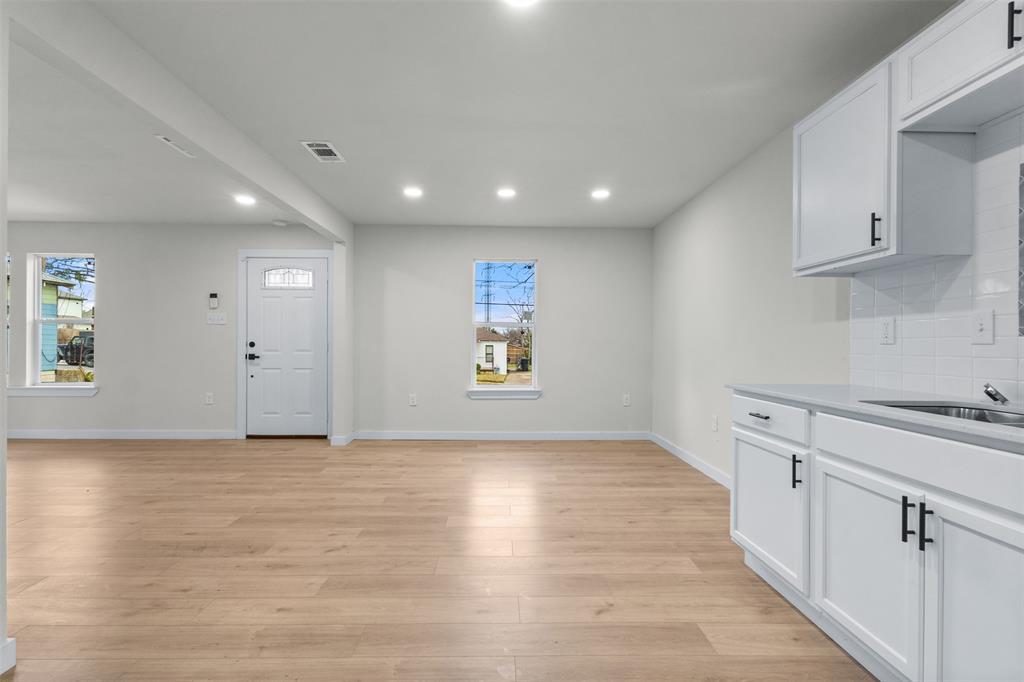 3915 Coolidge Street Dallas, TX 75215 - Photo 14 of 33 an empty room with wooden floor and windows