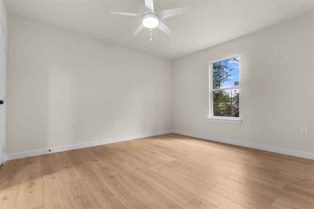 3915 Coolidge Street Dallas, TX 75215 - Photo 16 of 33 an empty room with wooden floor and windows