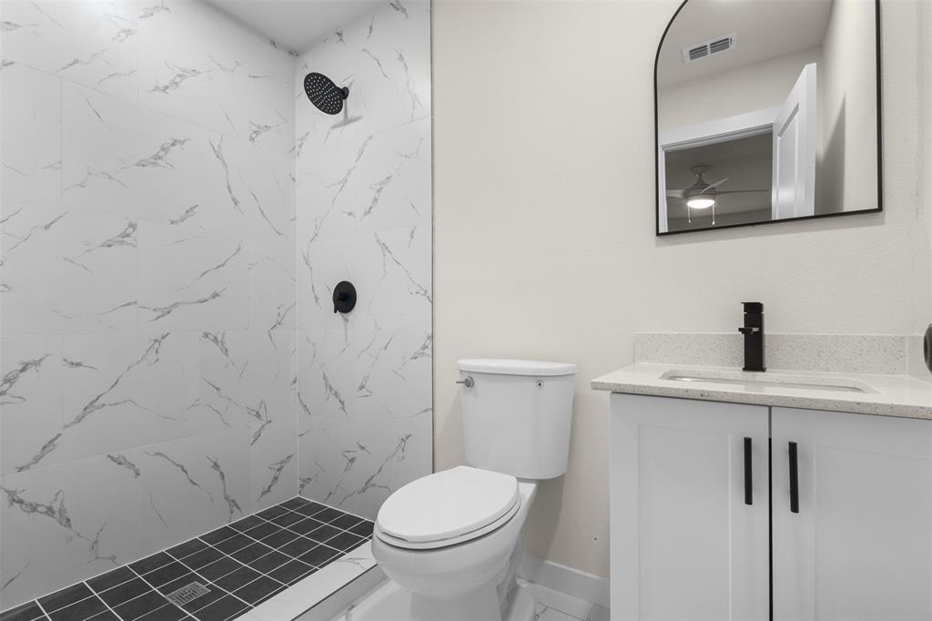 3915 Coolidge Street Dallas, TX 75215 - Photo 18 of 33 a bathroom with a toilet and a sink