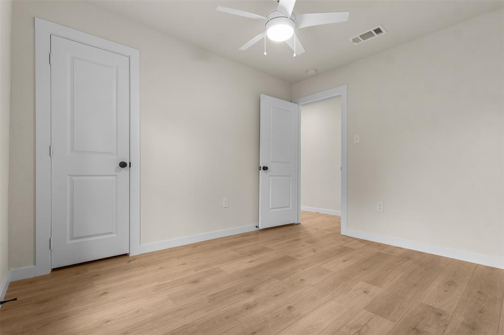 3915 Coolidge Street Dallas, TX 75215 - Photo 21 of 33 an empty room with wooden floor and ceiling fan