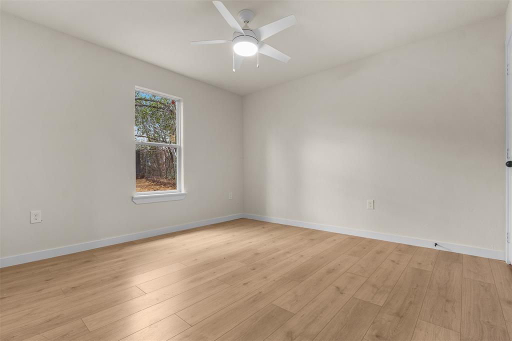 3915 Coolidge Street Dallas, TX 75215 - Photo 24 of 33 an empty room with a window and a fan