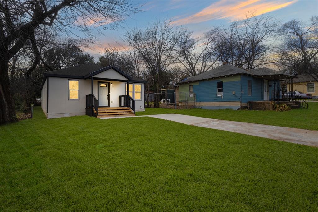 3915 Coolidge Street Dallas, TX 75215 - Photo 4 of 33 a front view of a house with a yard table and trees