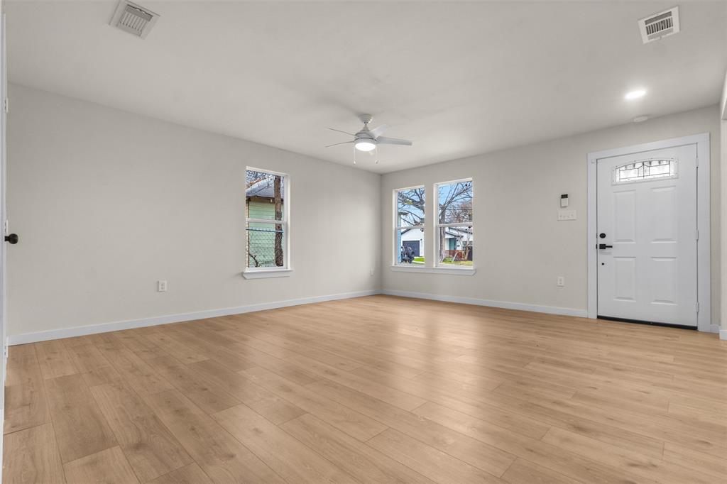3915 Coolidge Street Dallas, TX 75215 - Photo 9 of 33 wooden floor in an empty room with a window