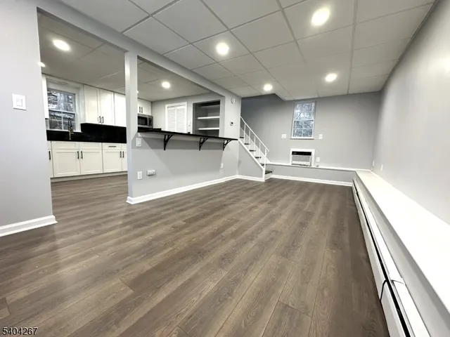 a view of a kitchen with a sink and wooden floor