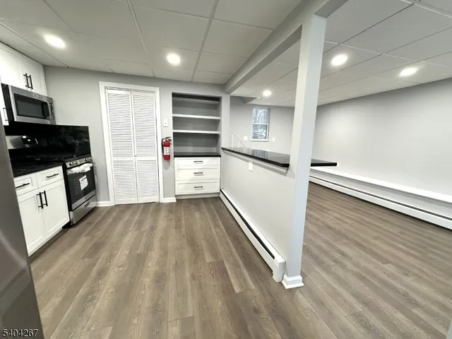 a kitchen with refrigerator and microwave