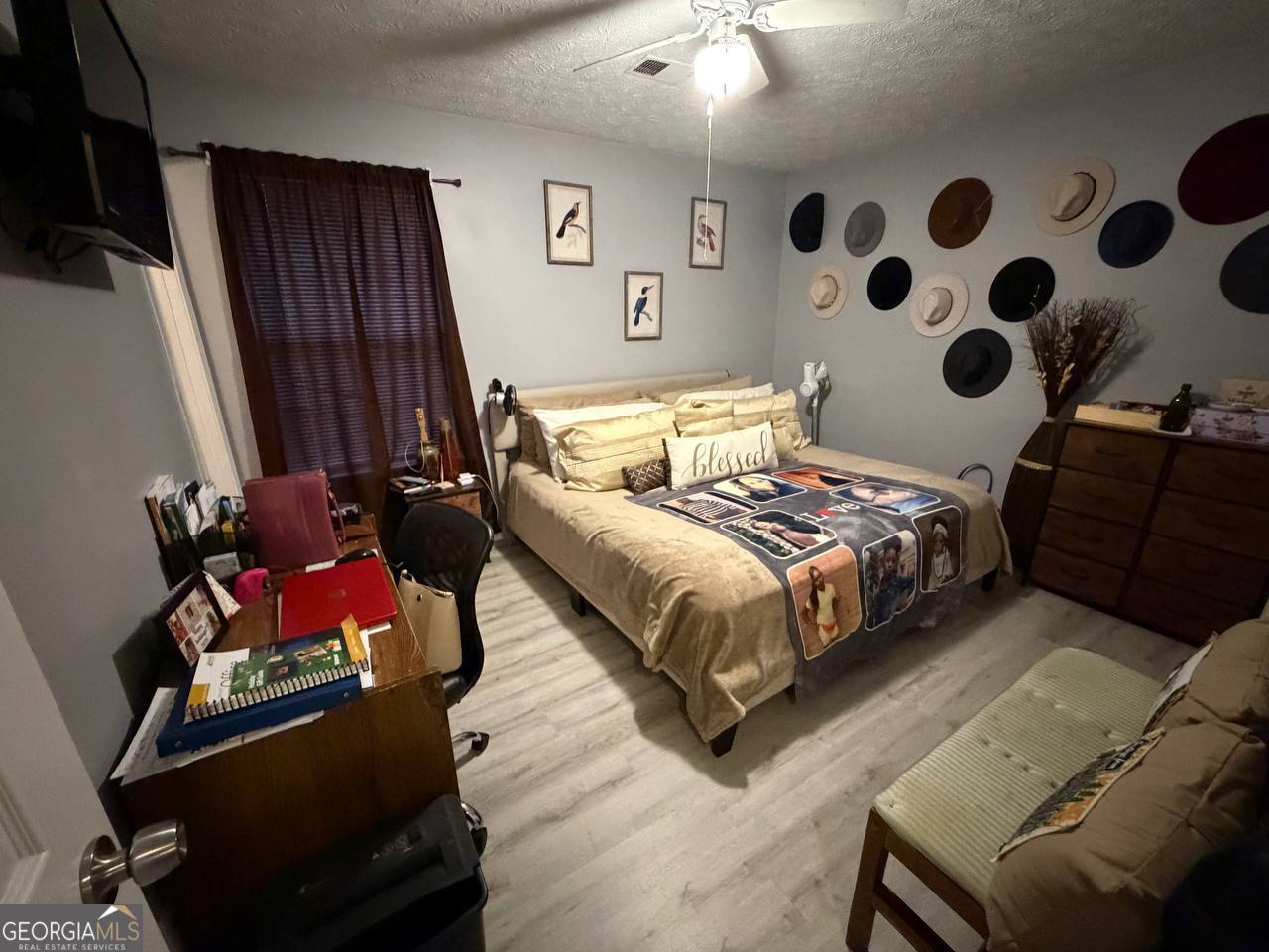 1137 Reed Place Monroe, GA 30655 - Photo 6 of 10 a bedroom with a bed and wooden floor