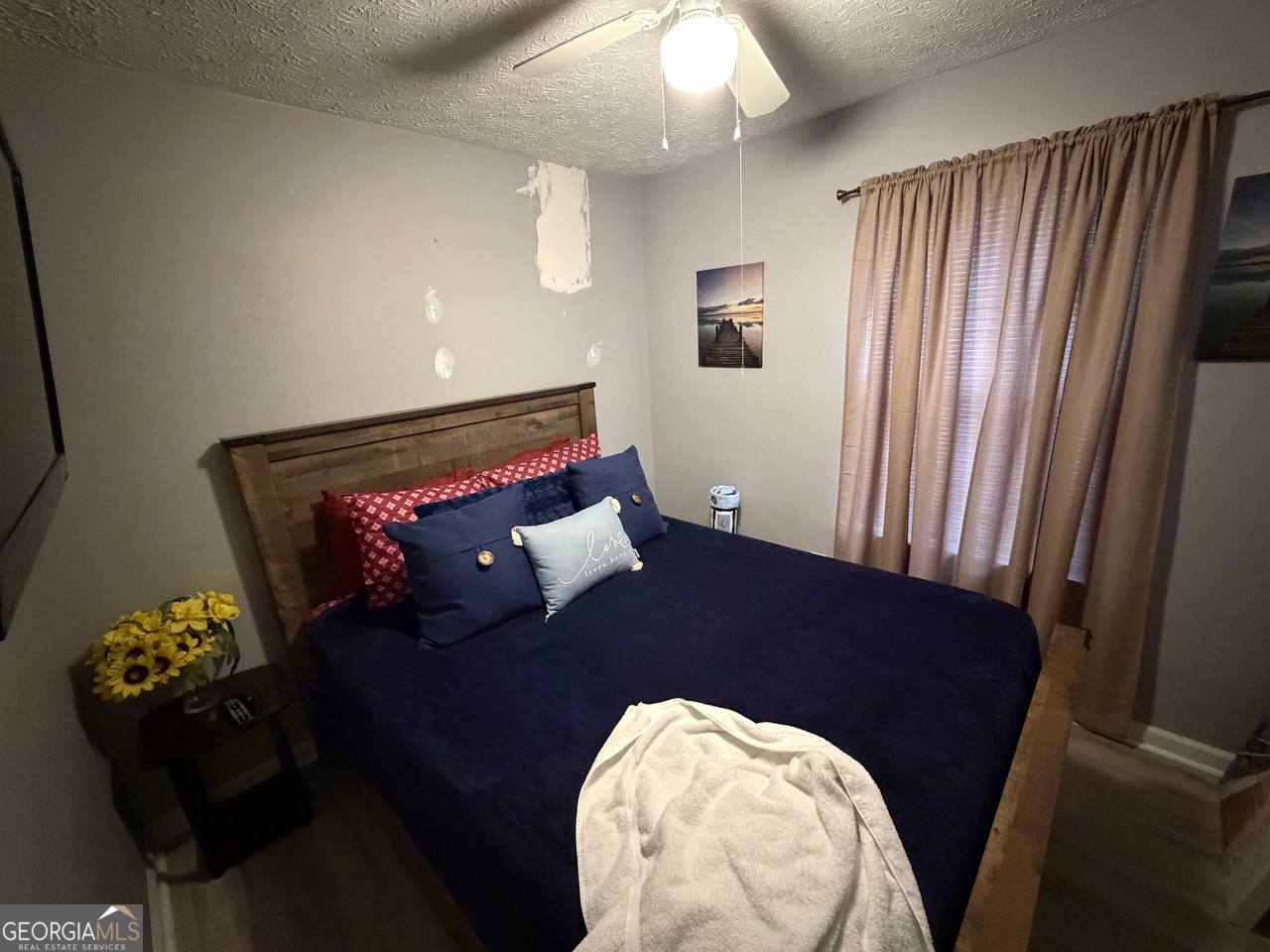 1137 Reed Place Monroe, GA 30655 - Photo 7 of 10 a bed sitting in a bedroom next to a window