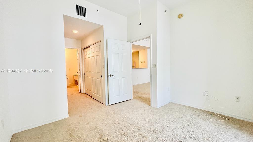 1209 Main Street, Unit 315 Jupiter, FL 33458 - Photo 12 of 18 an empty room with a mirror