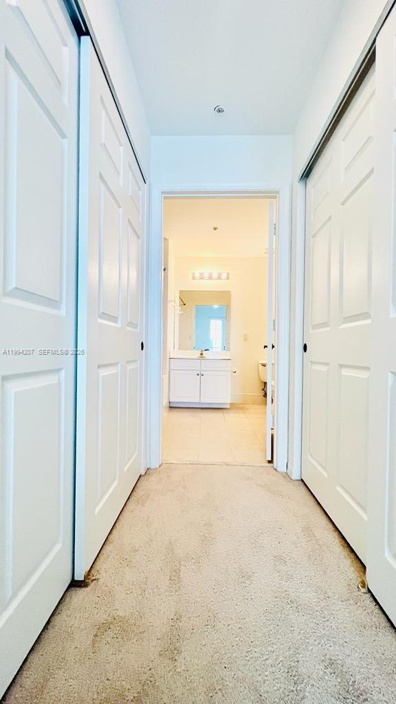 1209 Main Street, Unit 315 Jupiter, FL 33458 - Photo 13 of 18 an empty room with a bathroom and a mirror