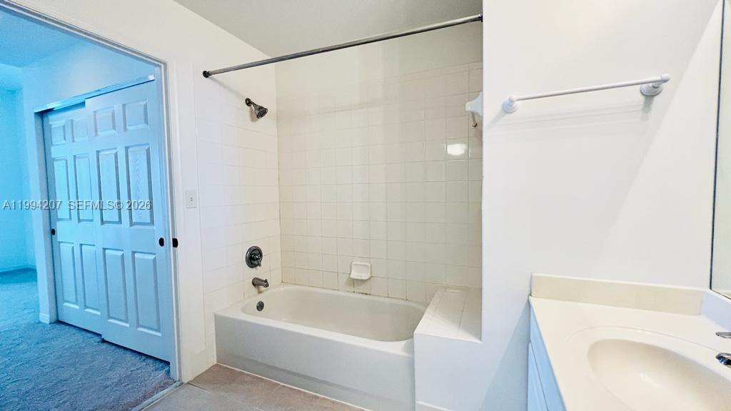 1209 Main Street, Unit 315 Jupiter, FL 33458 - Photo 15 of 18 a bathroom with a sink a bathtub and a shower