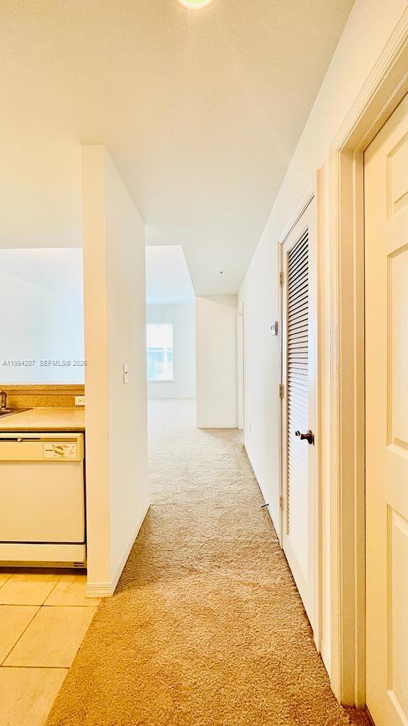 1209 Main Street, Unit 315 Jupiter, FL 33458 - Photo 2 of 18 a view of a hallway with wooden floor and cabinet