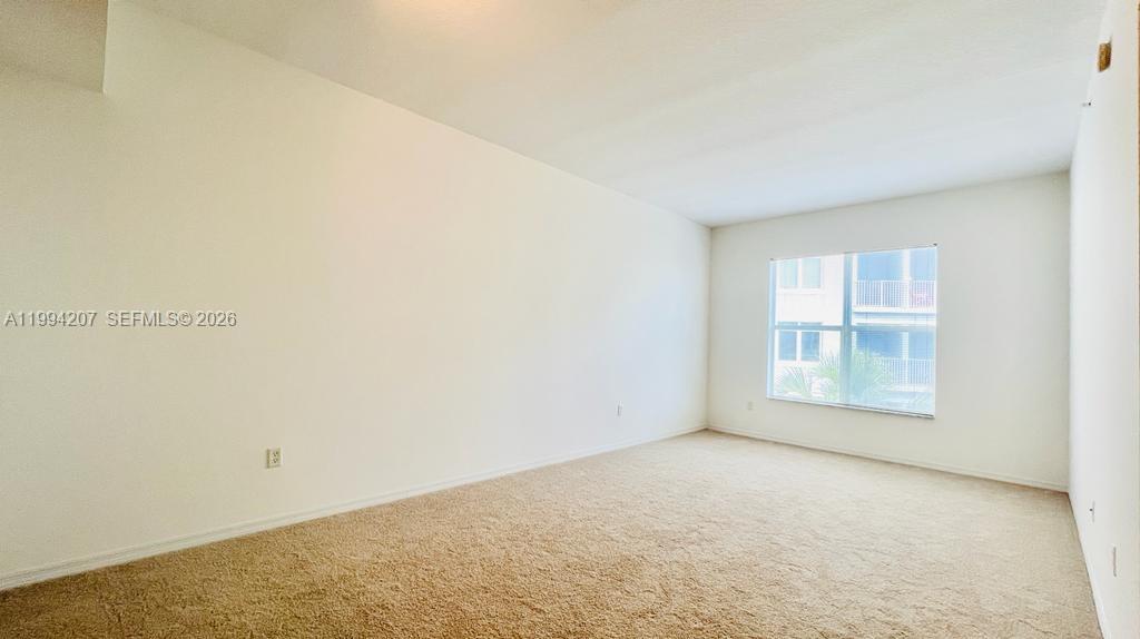1209 Main Street, Unit 315 Jupiter, FL 33458 - Photo 3 of 18 an empty room with a window